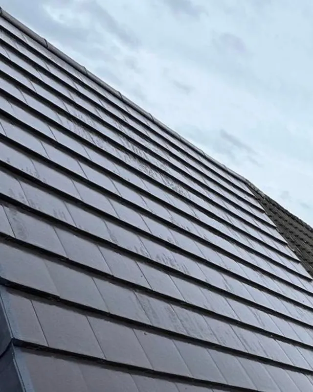 Grey concrete tiles laid to a new roof slope