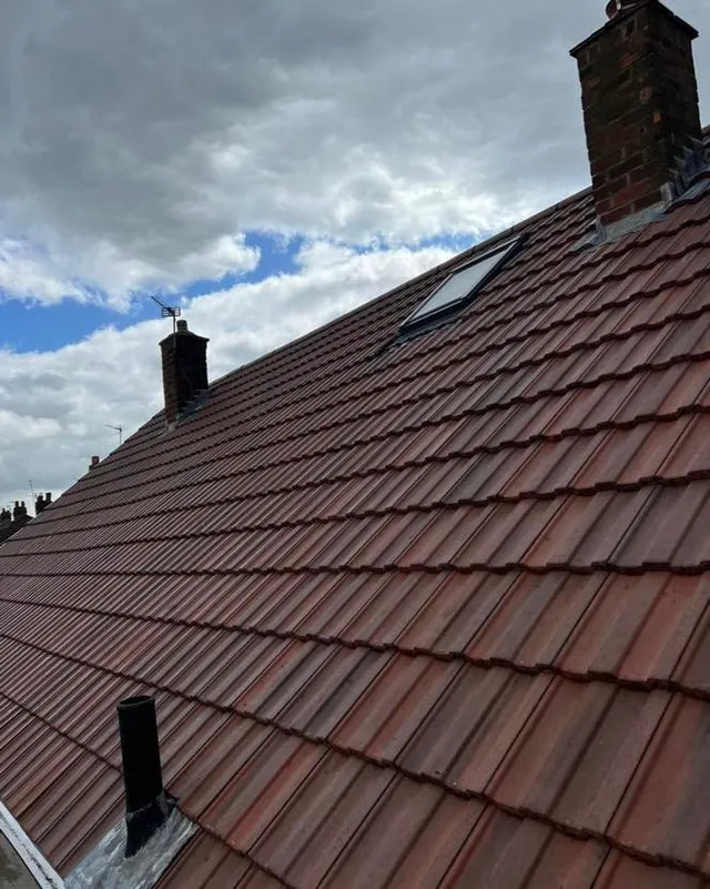 Completed grey tiled roof with chimney