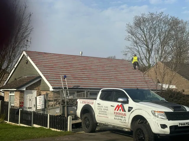 The team re-roofing a bungalow