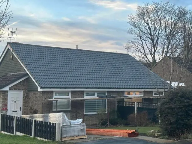 Finished bungalow re-roof in grey tile