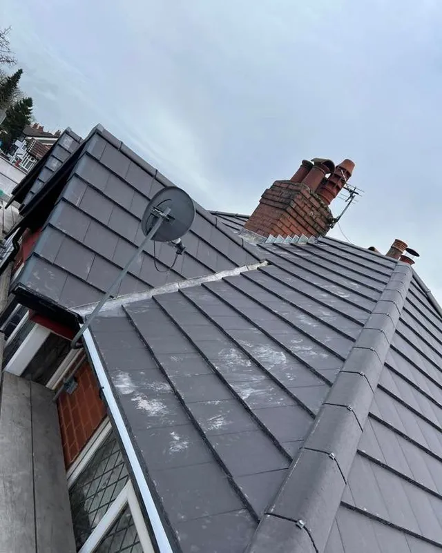 Re-tiled roof around a chimney stack